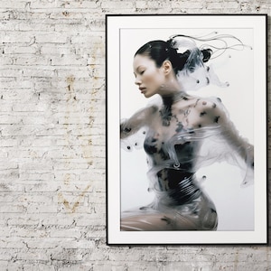 May include: A framed art print featuring a woman in a transparent garment with black accents. The artwork is set against a white background, with the woman's form partially obscured by the translucent material. The print is displayed on a white brick wall.