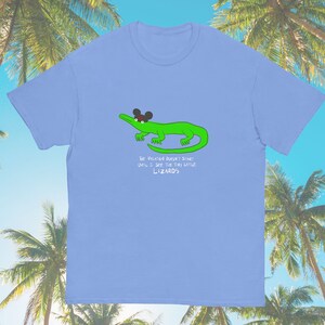 May include: Light blue t-shirt with a green alligator wearing a Mickey Mouse hat. The text on the shirt reads "The fun doesn't start until I see the tiny little lizards."