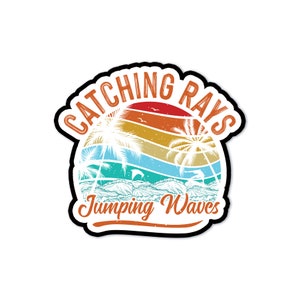 May include: A sticker with a beach scene design. The design features a sunset with palm trees, waves, and dolphins. The text "Catching Rays" and "Jumping Waves" are in a retro font.