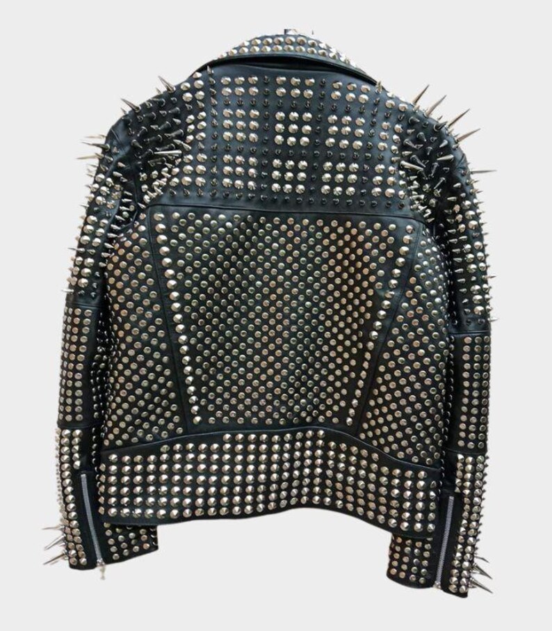 May include: Black leather jacket heavily embellished with silver studs and spikes. The back of the jacket is covered in small, round studs, with larger spikes along the shoulders and collar. Zippers are visible on the sleeves.