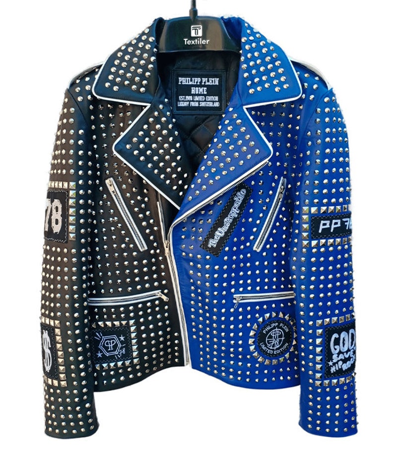 May include: A black and blue leather jacket with silver studs. The jacket has several patches, including "78", "The Unstoppable", "PP 78", "Philipp Plein Home", "God Save Hip Hop", and a dollar sign.