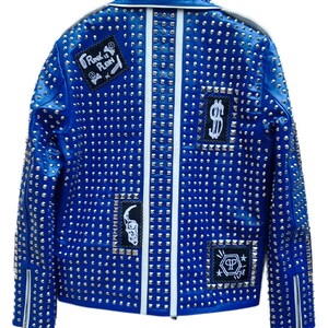 May include: A blue leather jacket with silver studs and patches. The patches include a skull, a dollar sign, and the text "Punk is Plain".