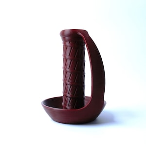 May include: A maroon-colored, 3D printed handle with a textured grip and a curved base.