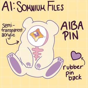 May include: A white bear-shaped pin with a translucent yellow and purple eye. The pin is made of semi-transparent acrylic and has a rubber pin back. The text "AIBA PIN" is written in purple on the right side of the image.