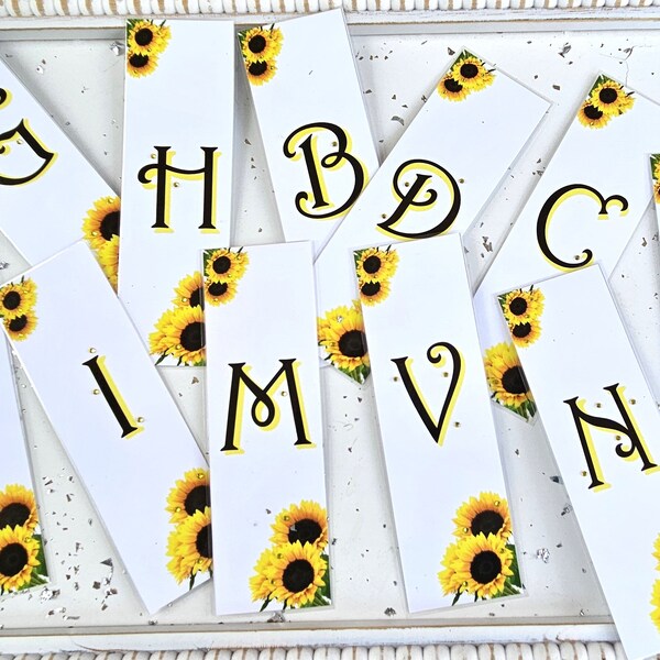 Initial sunflower bookmarks! 2.5x8 inches. Covered in 3 to 5 mil lamination. And bling of course!