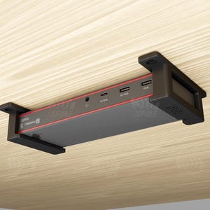 May include: A black and gray electronic device with red accents, mounted on a light wood surface. The device has multiple USB ports and the text "130PHILE" and "SMART 5" printed on it.