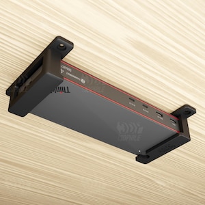 May include: A black and gray ThinkPad Thunderbolt 4 Smart dock, mounted on a light wood surface. The dock has red accents and multiple ports. The text "130PHILE" is visible on the dock.