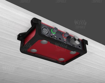 May include: A black and red audio interface with knobs and buttons, mounted to a wooden surface with a black bracket.