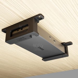 May include: A black Dell docking station mounted under a light wood surface. The docking station has multiple ports and the Dell logo. The mounting brackets are visible.