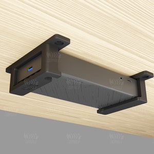 May include: A black computer device with a blue USB port is mounted to the underside of a wooden surface using a bracket.