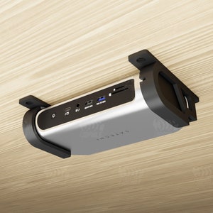 May include: A silver and black device with multiple ports mounted to a wooden ceiling. The device has the text "SATECCHI" printed on it.