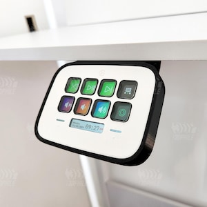 May include: A white and black remote control with nine buttons. The buttons are labeled with icons for play, pause, rewind, fast forward, volume up, volume down, and a square icon. The remote control also has a digital display showing the time 09:27.