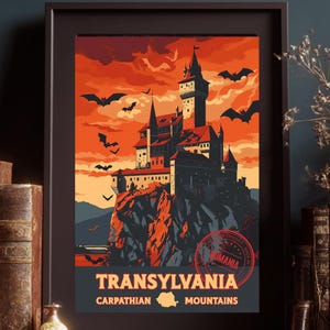 May include: Framed art print featuring a castle on a cliff under an orange sky with bats. The print reads "Transylvania" and "Carpathian Mountains" in white text. A red stamp with the word "Romania" is also visible.