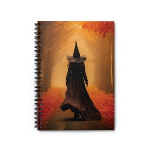 May include: A woman in a black witch's hat and dress walks down a path in a foggy forest. The leaves on the trees are a vibrant orange and red.