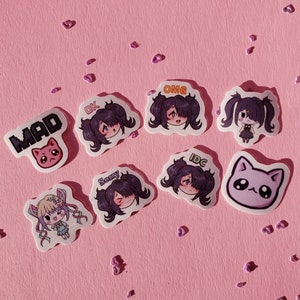 May include: A set of nine stickers featuring cartoon characters with different expressions. The stickers have text on them, including "MAD", "OK", "OMG", "Sorry", "IDC", and a pink cat with a heart.