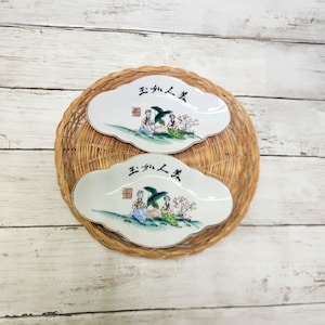 May include: A set of three ceramic mugs with a speckled, matte finish. Each mug features a different color: light blue, cream, and gray. The mugs have a simple, modern design and a comfortable handle.