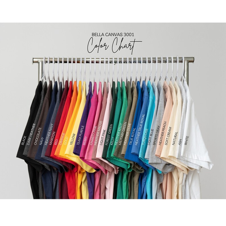 May include: A colour chart of Bella Canvas 3001 t-shirts, displaying a range of colours, including black, dark heather, chocolate, navy, heather navy, maroon, red, orange, gold, yellow, team purple, berry, charity pink, heather mauve, light pink, forest green, kelly, heather kelly, military green, heather olive, true royal, heather true royal, turquoise, light blue, sports grey, heather peach, soft cream, natural, ash, and white.