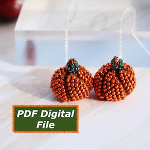 May include: Two orange beaded pumpkin earrings with green and brown detailing. The earrings are suspended by fine, clear threads. The image also features a green and orange rectangle with the text "PDF Digital File".