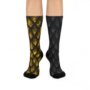 May include: A pair of socks with a dragon scale pattern. One sock is black and the other is gold.