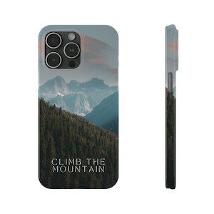 May include: A phone case featuring a scenic mountain landscape with a forest in the foreground and the text "CLIMB THE MOUNTAIN" in white. The case has a light blue border and a side view showing the case's thickness.