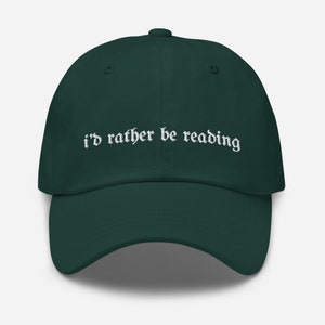 Peut inclure: Une casquette de baseball vert foncé avec un texte brodé blanc qui dit "i'd rather be reading".