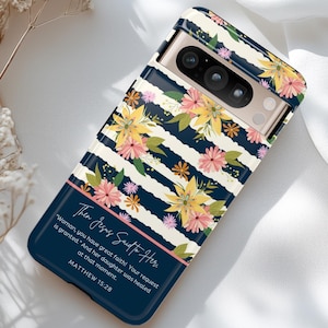 May include: A navy blue phone case with a white and black striped pattern and floral accents. The case features a quote from the Bible, Matthew 15:28, "Then Jesus Said to Her. 'Woman, you have great faith! Your request is granted.' And her daughter was healed at that moment."