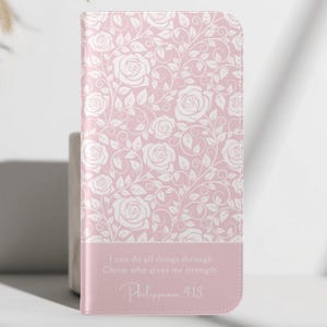 May include: A pink phone case with a white floral rose pattern. The bottom section features the text "I can do all things through Christ who gives me strength. Philippians 4:13."
