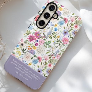 May include: A white phone case with a floral pattern and a quote from Galatians 5:22-23. The quote reads: "But the fruit of the Spirit is love, joy, peace, patience, kindness, goodness, faithfulness, gentleness and self-control."