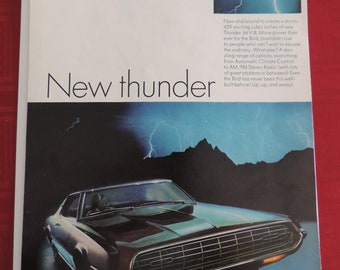 May include: A black 1968 Ford Thunderbird Hardtop with a chrome grille and headlights. The car is parked in front of a dark, rocky mountain range with lightning bolts in the sky. The text "New thunder" is written in large, bold letters above the car.