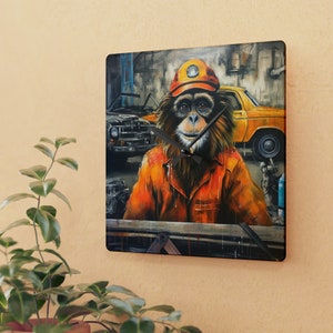 May include: A square clock with a colorful image of a monkey wearing a yellow hard hat and orange overalls. The monkey is in a garage setting with a vintage car in the background.