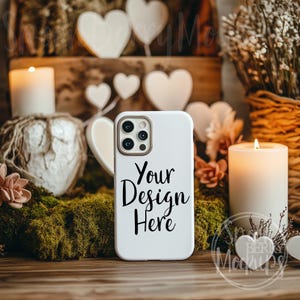 May include: White phone case mockup with a white background and the text "Your Design Here" in black. The phone case is surrounded by candles, moss, and decorative hearts.
