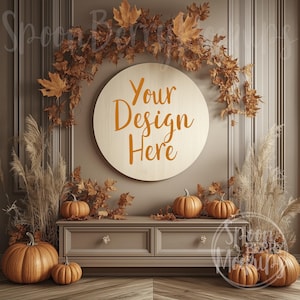 May include: A wooden round sign with the text "Your Design Here" in orange script, surrounded by fall foliage and pumpkins. The sign is hanging on a wall with a decorative molding.