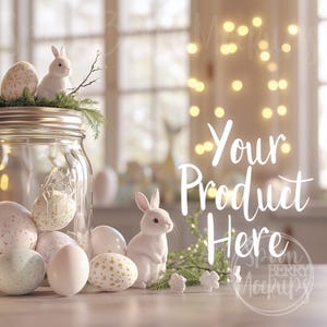 May include: A white ceramic bunny sits on a table with a glass jar filled with Easter eggs. The jar is decorated with a sprig of greenery and a white bunny. The background is a blurred image of a window with light shining through. The text "Your Product Here" is written in white on a blurred background.