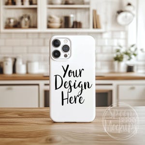 Op de afbeelding: Witte iPhone-hoes mockup met een zwarte tekstoverlay die "Your Design Here" zegt.
