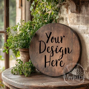 May include: A round wooden sign with a rustic brown finish. The sign has the text "Your Design Here" printed in black.