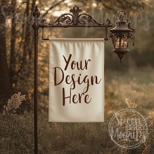 May include: A white banner with the text "Your Design Here" hanging from a black metal sign post with a decorative lantern. The banner is in a field of tall grass.