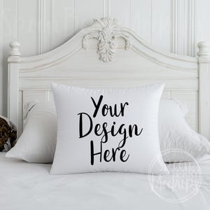 May include: White pillow with a white bed behind it. The pillow has black text that says "Your Design Here".