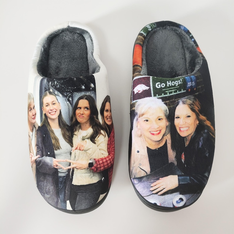 May include: A pair of plush, indoor slippers. One slipper features a group of women, the other has a different group of women with the text "Go Hogs!". Both slippers have a soft, gray interior.