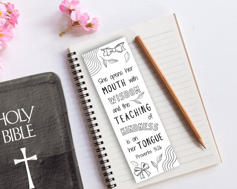 May include: Black and white bookmark with a decorative bow and leaves. The bookmark features a quote from Proverbs 31:26: "She opens her mouth with wisdom and the teaching of kindness is on her tongue."