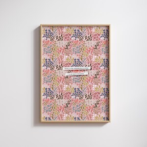 May include: A framed print with a pink background and a floral pattern in shades of blue, green, and red. The print features the text "Verily, in the remembrance of Allah do hearts find peace."
