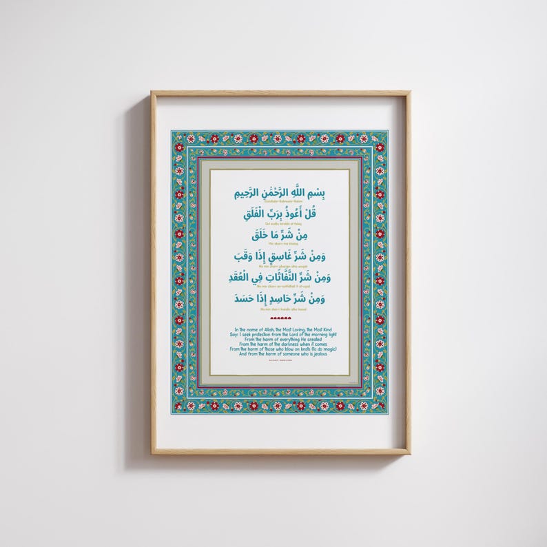 May include: A framed print with a blue and red floral border. The print features a white background with Arabic text in black. The text is a prayer for protection from harm. The text is translated in English below the Arabic text.