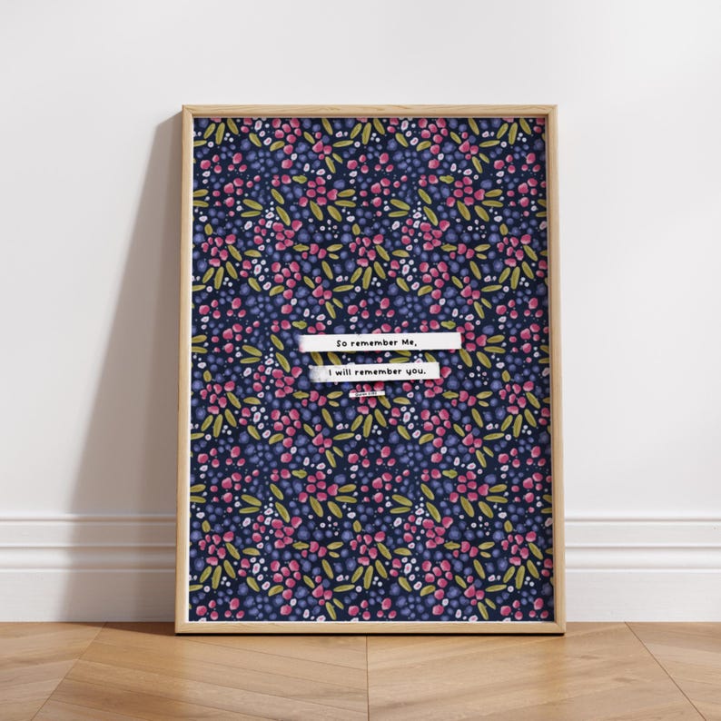 Pu&ograve; includere: Una stampa incorniciata con uno sfondo blu navy e un motivo ripetitivo di fiori rosa e verdi. La stampa presenta il testo "So remember me, I will remember you."