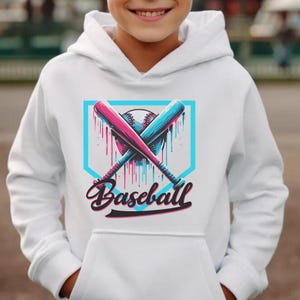 May include: White hoodie with a baseball graphic. The design features crossed pink and blue baseball bats, a baseball, and the word "Baseball" in a script font, set within a teal frame.