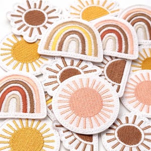 May include: A white ceramic mug with a black handle and the text "But First, Coffee" in a bold, black font. The mug is set against a blurred background, highlighting its clean design.