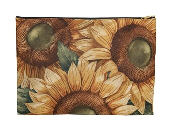 May include: A rectangular zippered pouch featuring a detailed floral pattern of sunflowers in shades of yellow, brown, and green. The sunflowers are densely packed, creating a vibrant and textured design. The zipper is gold-colored.