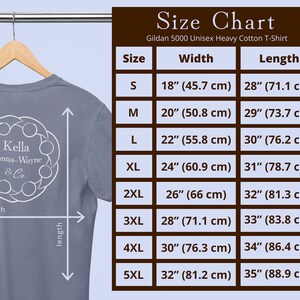 A basic grey-blue T-shirt on a hanger with the Kella Hanna-Wayne and Co logo on it. Next to it is a brown and blue size chart showing measurements for sizes small through 5XL. Sizing details are listed in the product description.