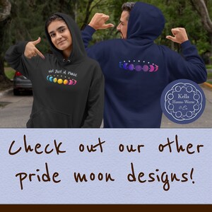 Two queer friends demo hoodies with seven phases of the moon in a gradient of pride colors: to the right bisexual pride, to the left pansexual pride and the words Not Just a Phase above. Text below reads: Check out our other pride moon designs!