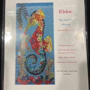 May include: A pattern sheet titled Ebba by Laura Heine featuring a colorful seahorse collage on a blue background. The text includes the dimensions about 23 x 42 inches, company contact information for Fiberworks Inc, and a copyright notice.