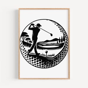 May include: Black and white golf-themed art print. The artwork depicts a golfer mid-swing within a golf ball-shaped design. The background shows a golf course with trees, water, and a tee. The print is framed in a light brown wooden frame.
