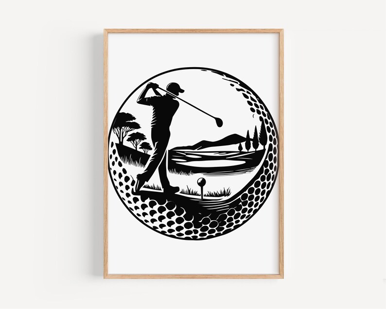 May include: Black and white golf-themed art print. The artwork depicts a golfer mid-swing within a golf ball-shaped design. The background shows a golf course with trees, water, and a tee. The print is framed in a light brown wooden frame.